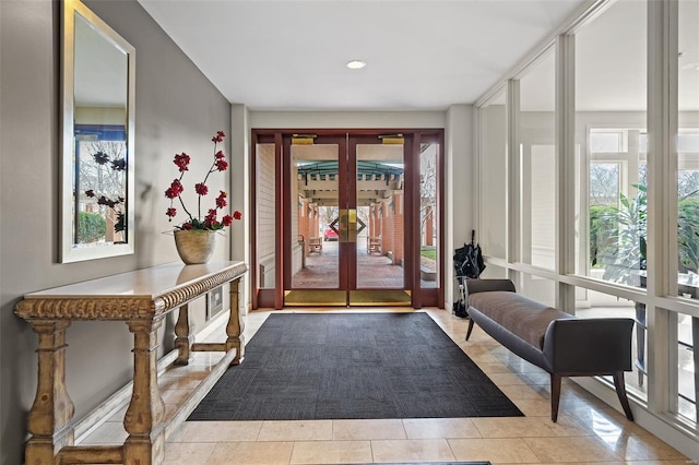 doorway to outside featuring tile patterned flooring and french doors