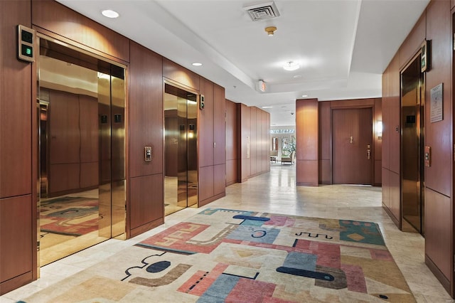 hall featuring light tile patterned flooring, elevator, visible vents, and recessed lighting