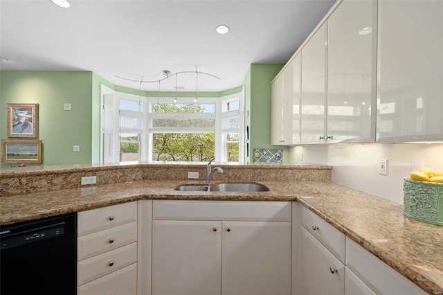 kitchen with light stone countertops, recessed lighting, white cabinetry, a sink, and dishwasher