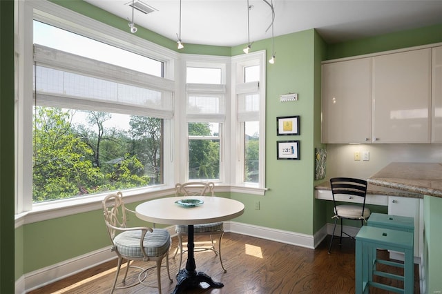 dining space featuring visible vents, baseboards, and dark wood-type flooring