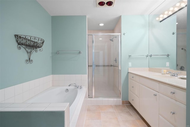 bathroom featuring vanity, tile patterned flooring, a stall shower, and a garden tub