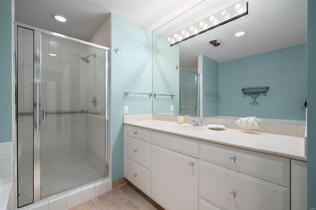 bathroom featuring vanity, tile patterned floors, and a shower stall
