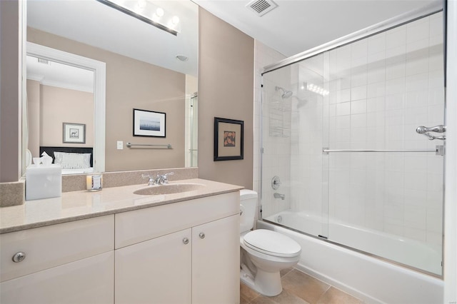 bathroom with visible vents, vanity, shower / bath combination with glass door, toilet, and tile patterned floors
