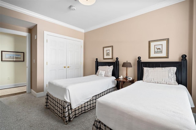 bedroom featuring crown molding, baseboards, a closet, and carpet floors