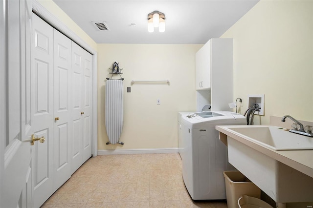 washroom featuring cabinet space, washer and dryer, a sink, baseboards, and visible vents