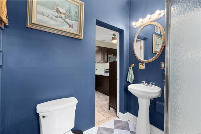 bathroom featuring ceiling fan, visible vents, a sink, tile patterned floors, and toilet