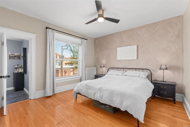 bedroom with baseboards, ceiling fan, and wood finished floors
