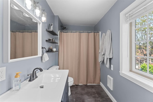 bathroom with vanity, baseboards, visible vents, and toilet