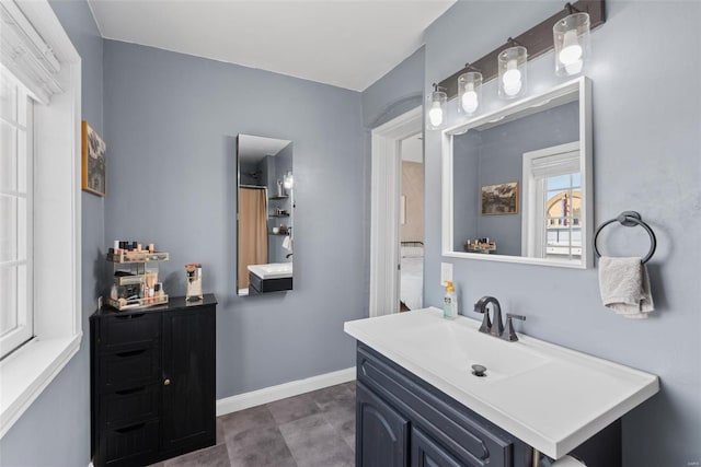 bathroom with baseboards and vanity