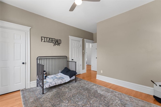 bedroom with baseboards, a ceiling fan, and wood finished floors