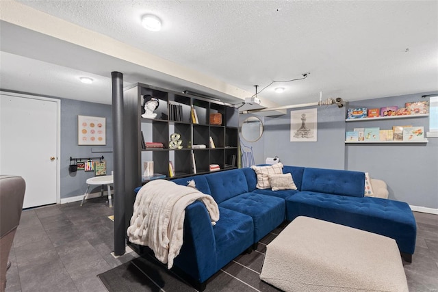 living room with a textured ceiling and baseboards