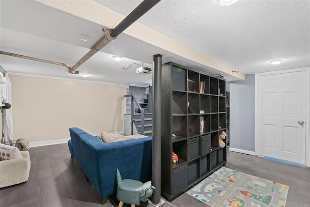 finished basement with stairway, baseboards, tile patterned flooring, and a textured ceiling