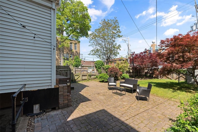 view of patio / terrace featuring fence and a gate