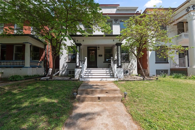 view of front of home featuring covered porch and a front lawn