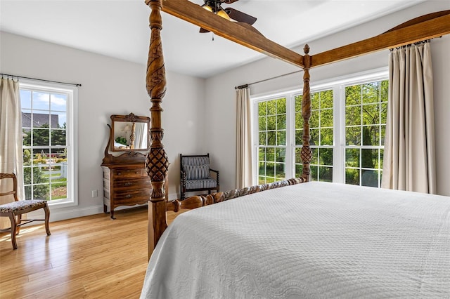 bedroom featuring baseboards, ceiling fan, and light wood-type flooring