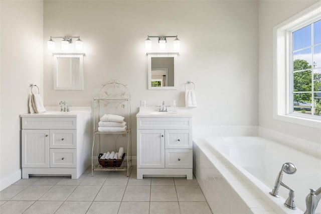 bathroom featuring tile patterned floors, two vanities, a sink, and a garden tub