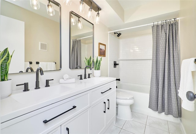 bathroom featuring a sink, double vanity, visible vents, and toilet