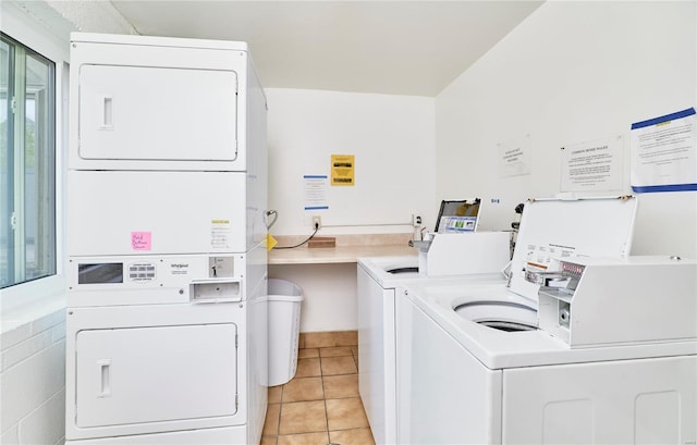shared laundry area with light tile patterned floors, stacked washer / drying machine, and independent washer and dryer