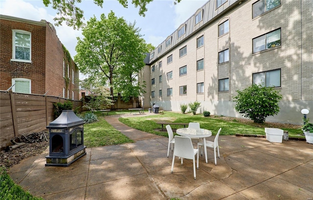 view of patio featuring outdoor dining space and fence