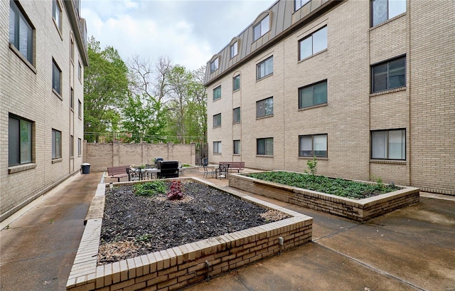 view of home's community with fence and a patio