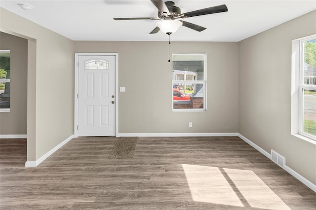 interior space featuring baseboards, visible vents, ceiling fan, and a healthy amount of sunlight
