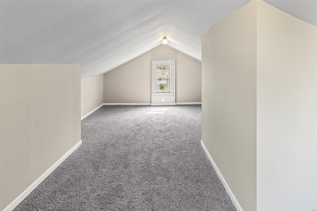 bonus room with vaulted ceiling, carpet floors, and baseboards