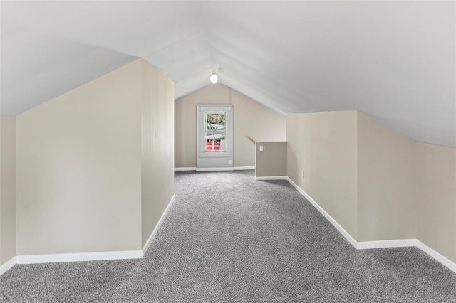 additional living space with lofted ceiling, carpet, and baseboards