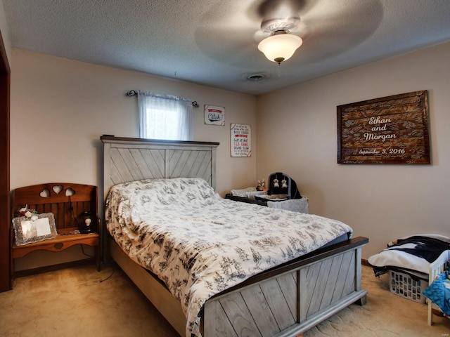 bedroom with visible vents, carpet flooring, and a ceiling fan