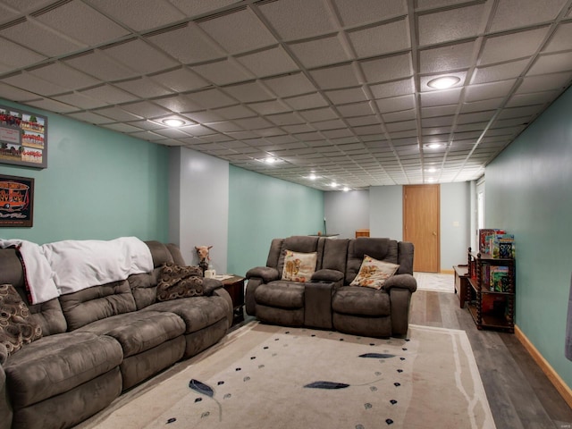 living room with baseboards, wood finished floors, and recessed lighting