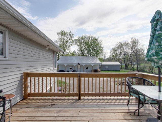 wooden terrace featuring an outdoor structure