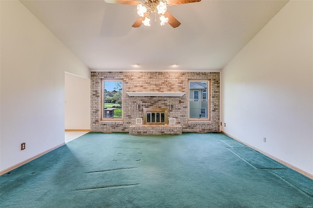unfurnished living room featuring baseboards, carpet, a ceiling fan, and a brick fireplace