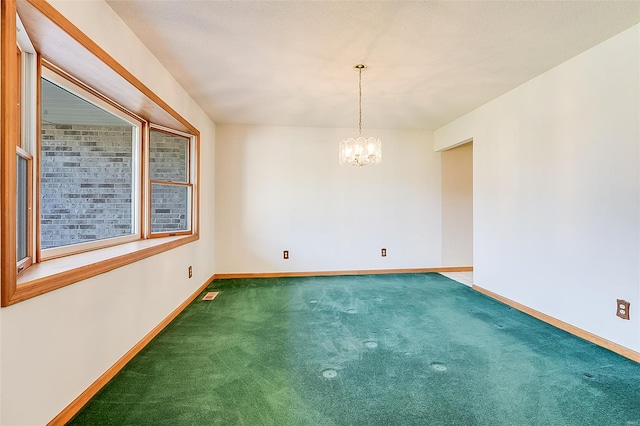 unfurnished room with carpet floors, baseboards, a chandelier, and visible vents