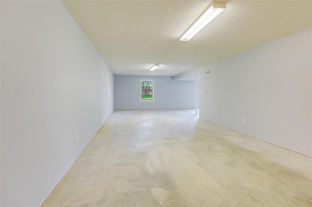 spare room with concrete flooring and a textured ceiling