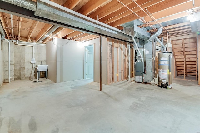 unfinished below grade area featuring heating unit and gas water heater