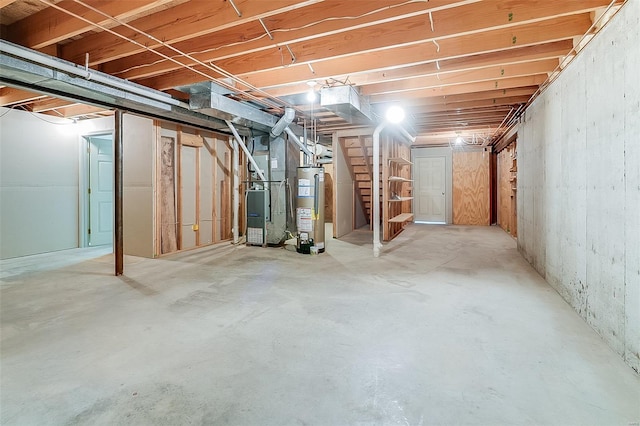 unfinished basement with stairs, heating unit, and gas water heater