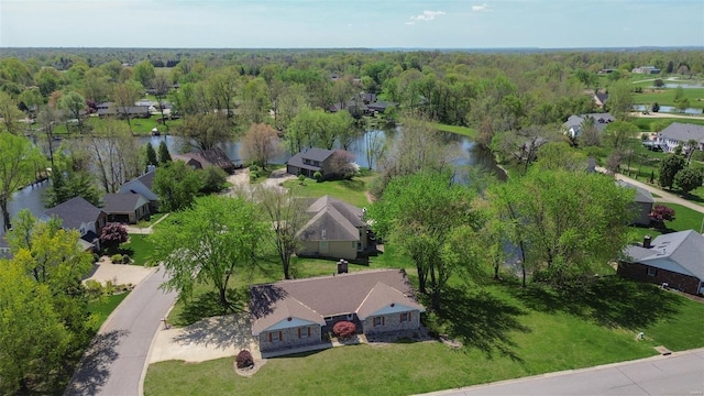 aerial view featuring a water view, a residential view, and a forest view