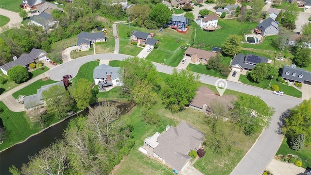 drone / aerial view with a water view and a residential view