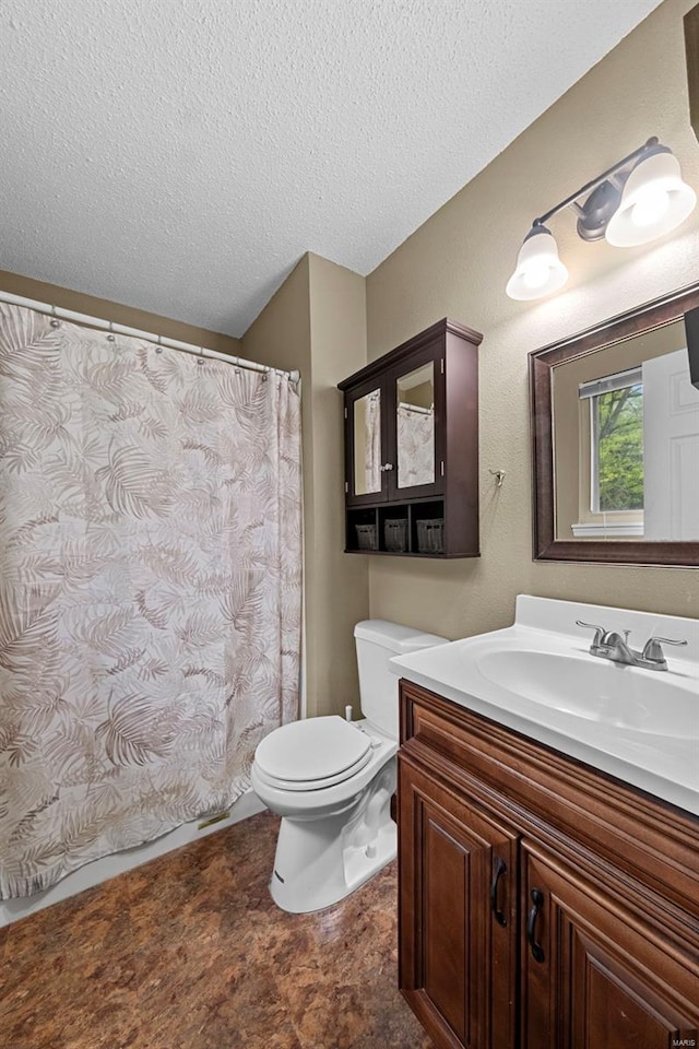 full bathroom with vanity, a textured ceiling, toilet, and a shower with curtain