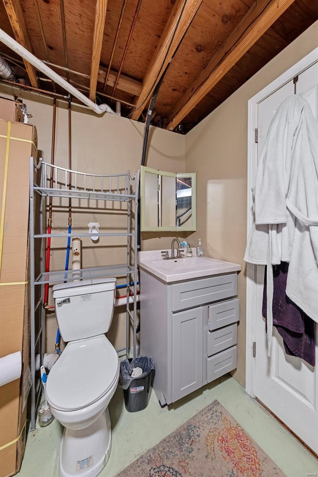 full bathroom with vanity, toilet, and concrete floors