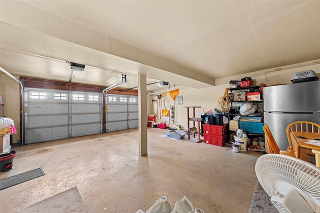 garage with freestanding refrigerator and a garage door opener