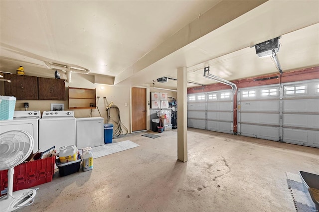 garage with a garage door opener and washer and dryer