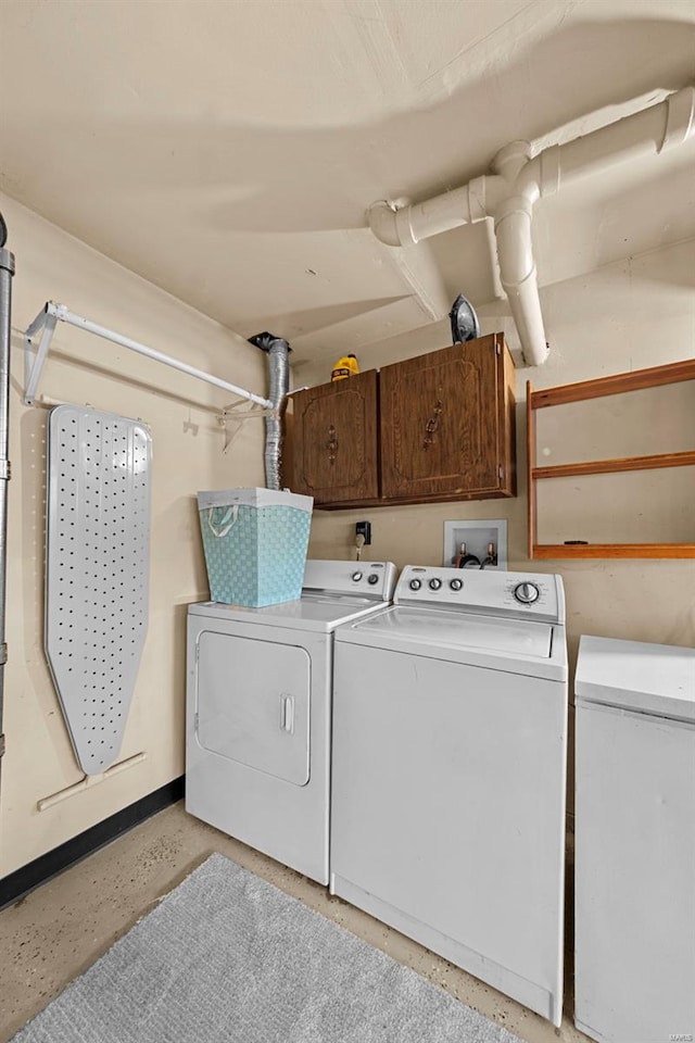 washroom featuring cabinet space and washing machine and clothes dryer