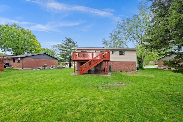 back of house with a lawn, stairs, a deck, and brick siding