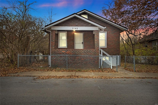 bungalow featuring fence private yard and brick siding