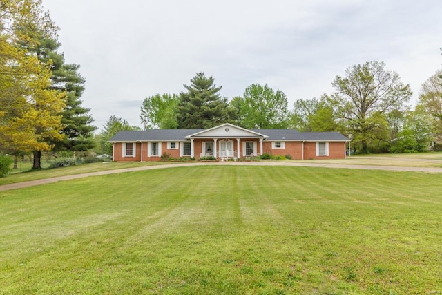 single story home featuring a porch and a front lawn