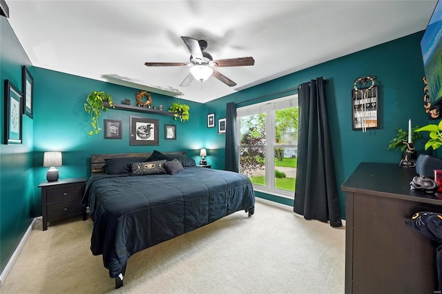 carpeted bedroom featuring baseboards and ceiling fan