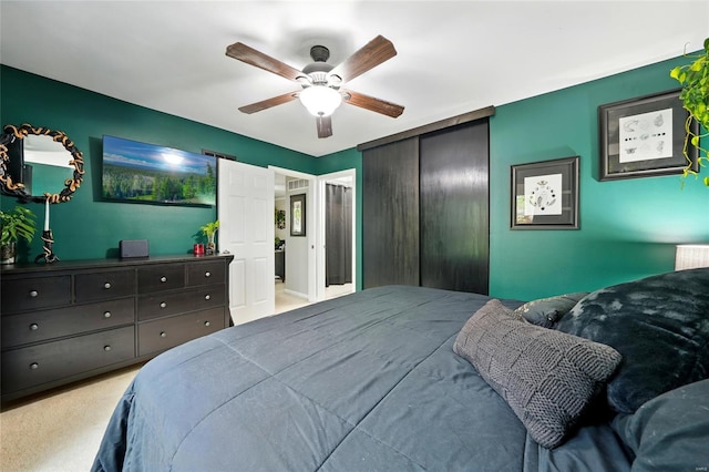 carpeted bedroom featuring a closet and ceiling fan