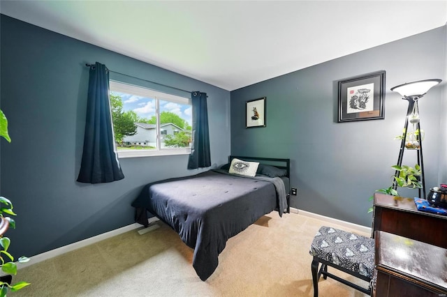bedroom featuring carpet and baseboards