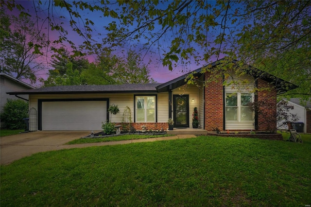 ranch-style home with concrete driveway, an attached garage, brick siding, and a front yard