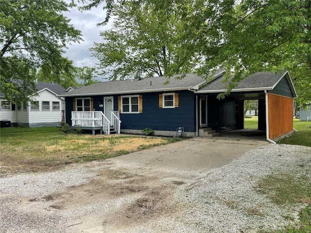 single story home featuring concrete driveway, a carport, a shingled roof, and central AC unit